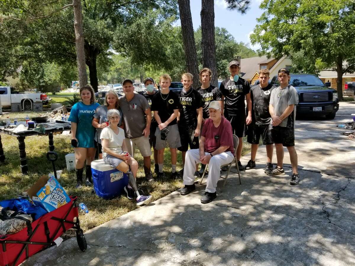 The Conroe Tigers baseball program volunteered in the River Plantation community on Thursday by helping residents clean out damaged materials from their flood-ravaged homes.