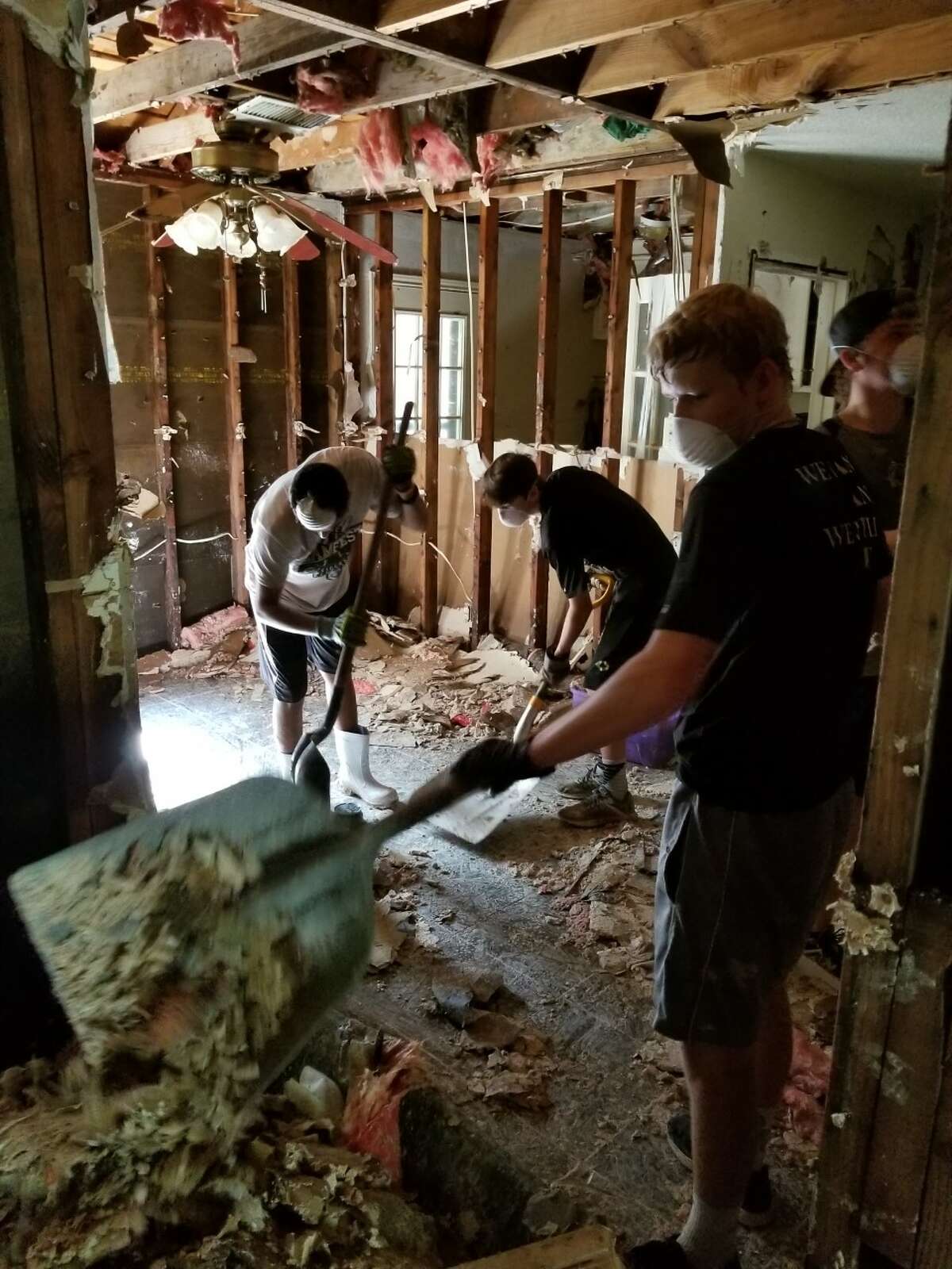 The Conroe Tigers baseball program volunteered in the River Plantation community on Thursday by helping residents clean out damaged materials from their flood-ravaged homes.