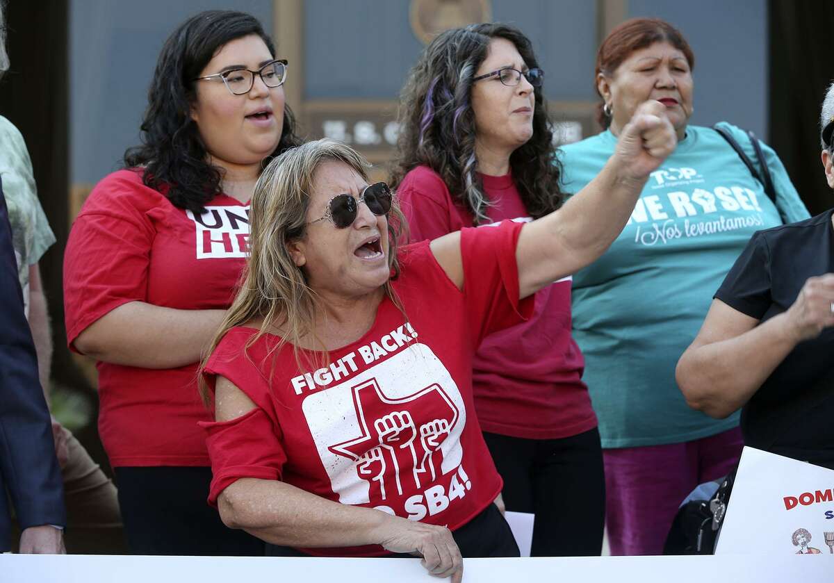 Araceli Herrera (center, arm raised) leads a chant Thursday August 31, 2017 in front of the John Wood Federal Courthouse on East Ceasar Chavez Boulevard after U.S. District Court Judge Orlando Garcia halted most of Texas?’ ban on sanctuary cities Wednesday ?— two days before the law was to take effect. In his ruling, U.S. District Judge Orlando Garcia halted penalties for officials who endorse policies in violation of Senate Bill 4, saying it likely violates the First Amendment. SB 4 allows the attorney general to fine or remove from office local officials who ?“adopt, enforce, or endorse a policy under which the entity or department prohibits or materially limits the enforcement of immigration laws.?” The law also creates penalties for local officials who block police from asking about immigration status.