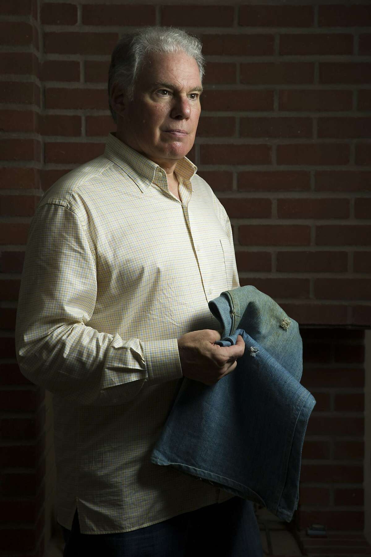 Howard Green stands for a portrait at his home on Thursday, Aug. 10, 2017, in Los Gatos, Calif. Green holds the pants he wore when he was wounded in the Golden Dragon massacre in San Francisco Chinatown on Sept. 4, 1977. His pants have three bullet holes and blood stains from the incident. The middle-of-the-night gang shooting at the packed Golden Dragon restaurant left five dead and wounded at least 11. None of the victims were the intended targets of the shooting.