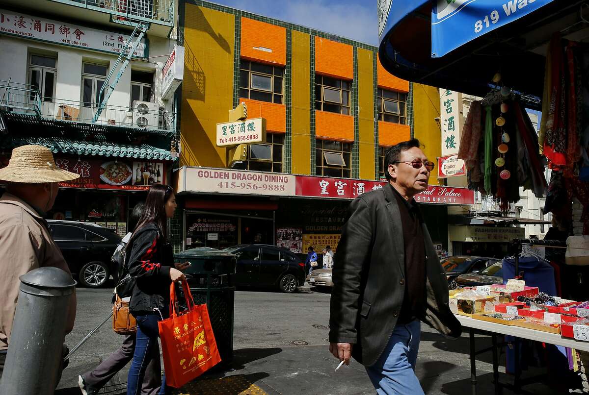 Pedestrians make their way through Chinatown past the Imperial Palace Restaurant on Tuesday, Aug. 29, 2017, in San Francisco, Calif. The Imperial Palace was formerly the Golden Dragon Restaurant, where the Golden Dragon Massacre took place on Sept. 4, 1977.