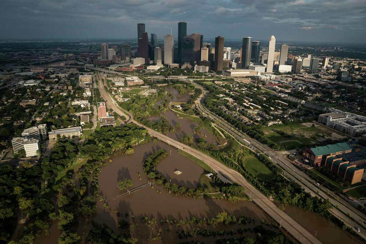 The sun sets on downtown Houston as flood waters still surround some neighborhoods.