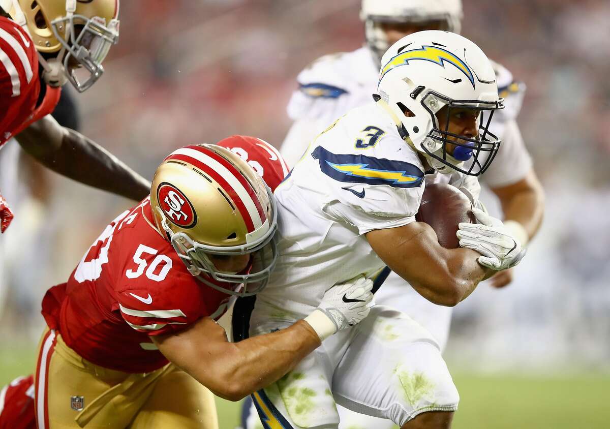 SANTA CLARA, CA - AUGUST 31: Austin Ekeler #3 of the Los Angeles Chargers is tackled by Brock Coyle #50 of the San Francisco 49ers at Levi's Stadium on August 31, 2017 in Santa Clara, California. (Photo by Ezra Shaw/Getty Images)