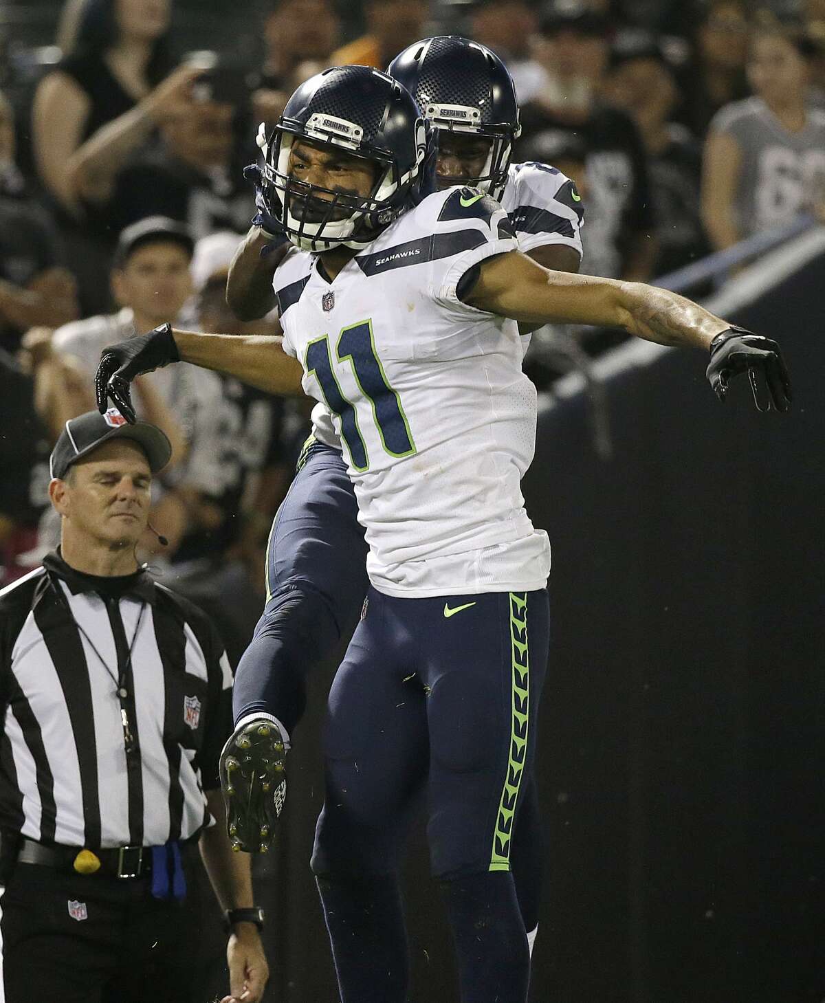Seahawks wide receiver Kenny Lawler (11) celebrates with wide receiver David Moore, rear, after scoring the game-winning touchdown.