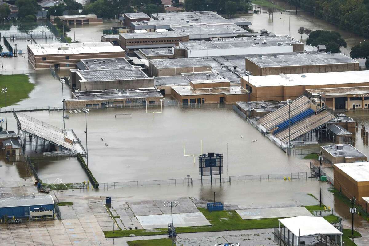 A football field at C.E. King High School is shown flooded by rising waters from Tropical Storm Harvey on Tuesday in Houston. The state is anticipating a major budget hit from having to address damaged school facilities as well as a lack of funding from property that may be lost as a result of the flooding.