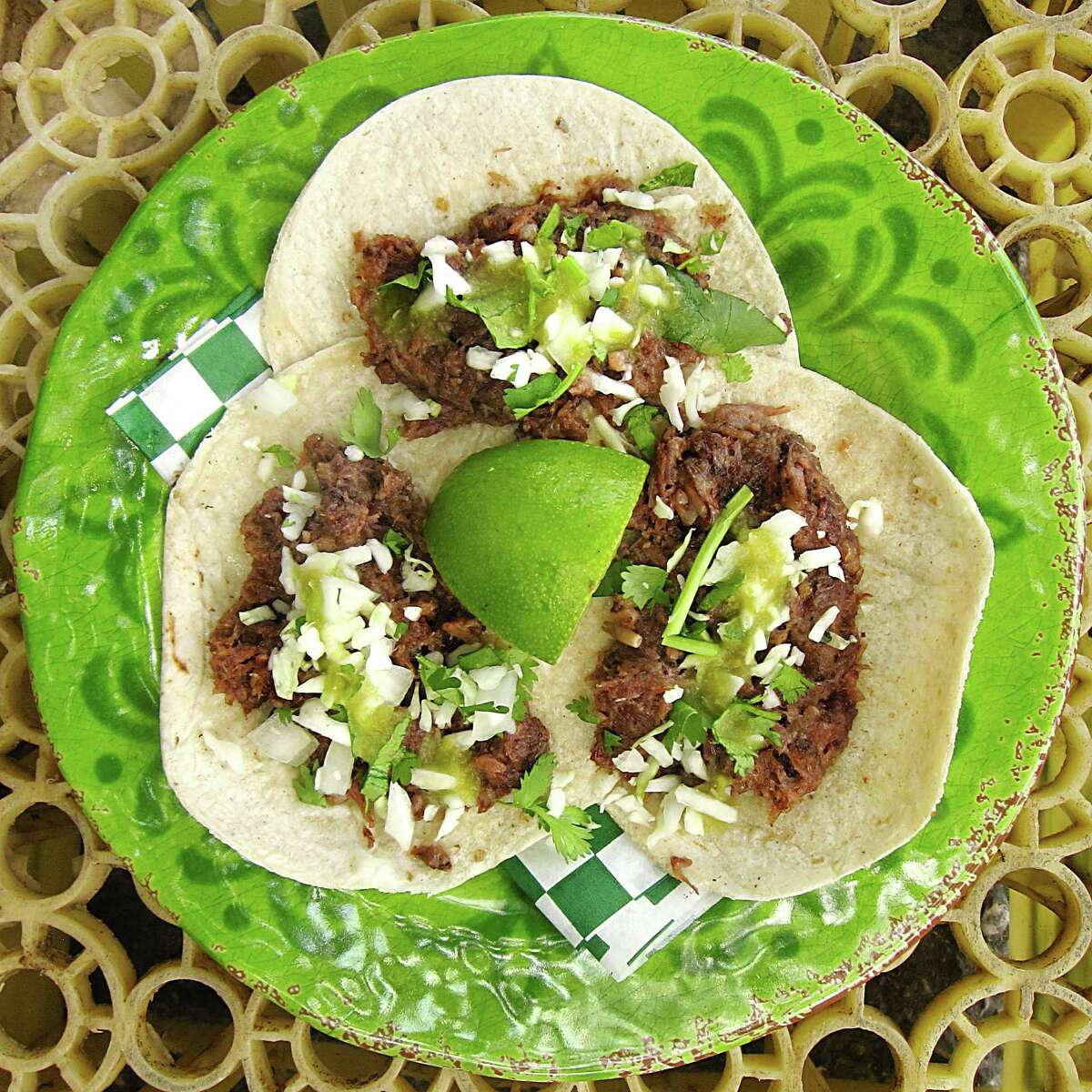 Barbacoa tacos with cabbage, cilantro and salsa verde on hot corn tortillas from the Tacos Lira truck.