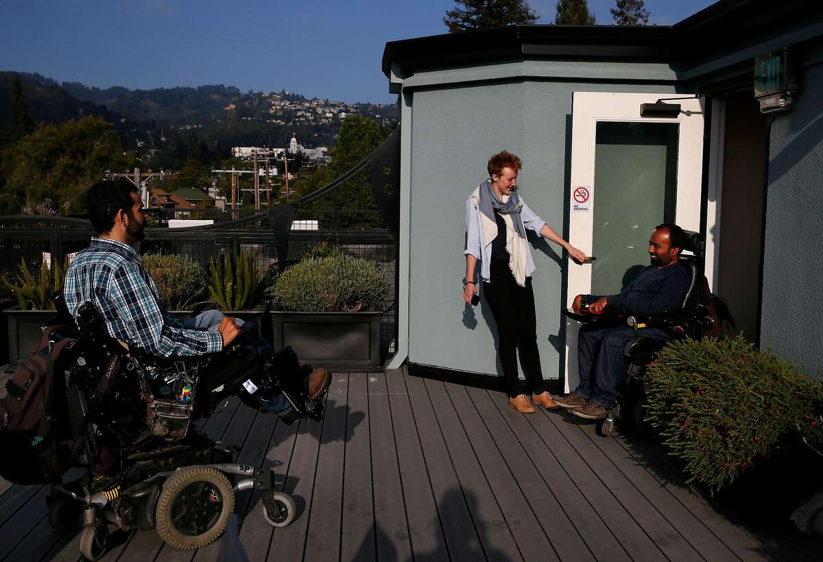 Alex Ghenis, left, shows Accomable co-founder and CEO Srin Madipalli, right, the roof as data scientist Vicky Clayton holds the door during a tour for the Chronicle August 23, 2017 in Berkeley, Calif. Ghenis is putting his apartment up on Accomable.