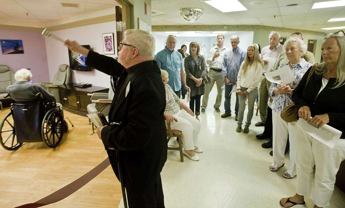 Reverend Paul Merry, of Saint John Paul II Center in Danbury, blesses the Neary Relaxation Room during a dedicated ceremony in honor of Donald M. Neary. Friday, Aug. 25, 2017
