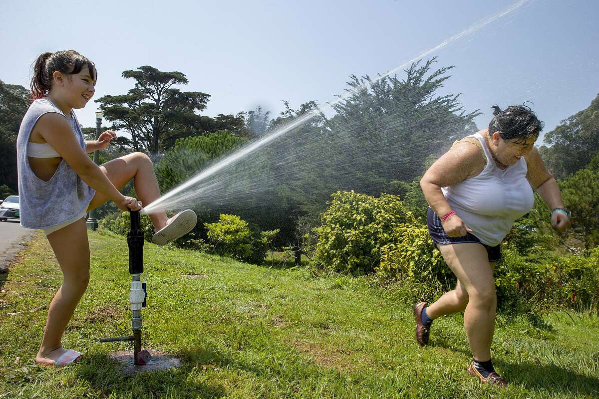 GALLERY: San Francisco is hotter than these cities right now From left: Amilia Madigan, age 11, and her mother Desy Stoyanov cool off from the heat using the water sprinklers at Golden Gate Park on Friday, Sept. 1, 2017, in San Francisco, Calif. The National Weather Service issued an excessive heat warning as the San Francisco Bay Area reached temperatures in the upper 90s and some areas surpassed 100 degrees.