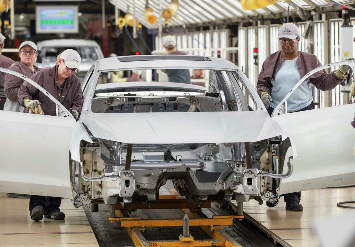 Workers produce vehicles at Volkswagen's lone U.S. plant in Chattanooga, Tenn. Volkswagen makes the Passat sedan at the plant and is ramping up production of the new seven-seat Atlas SUV.﻿