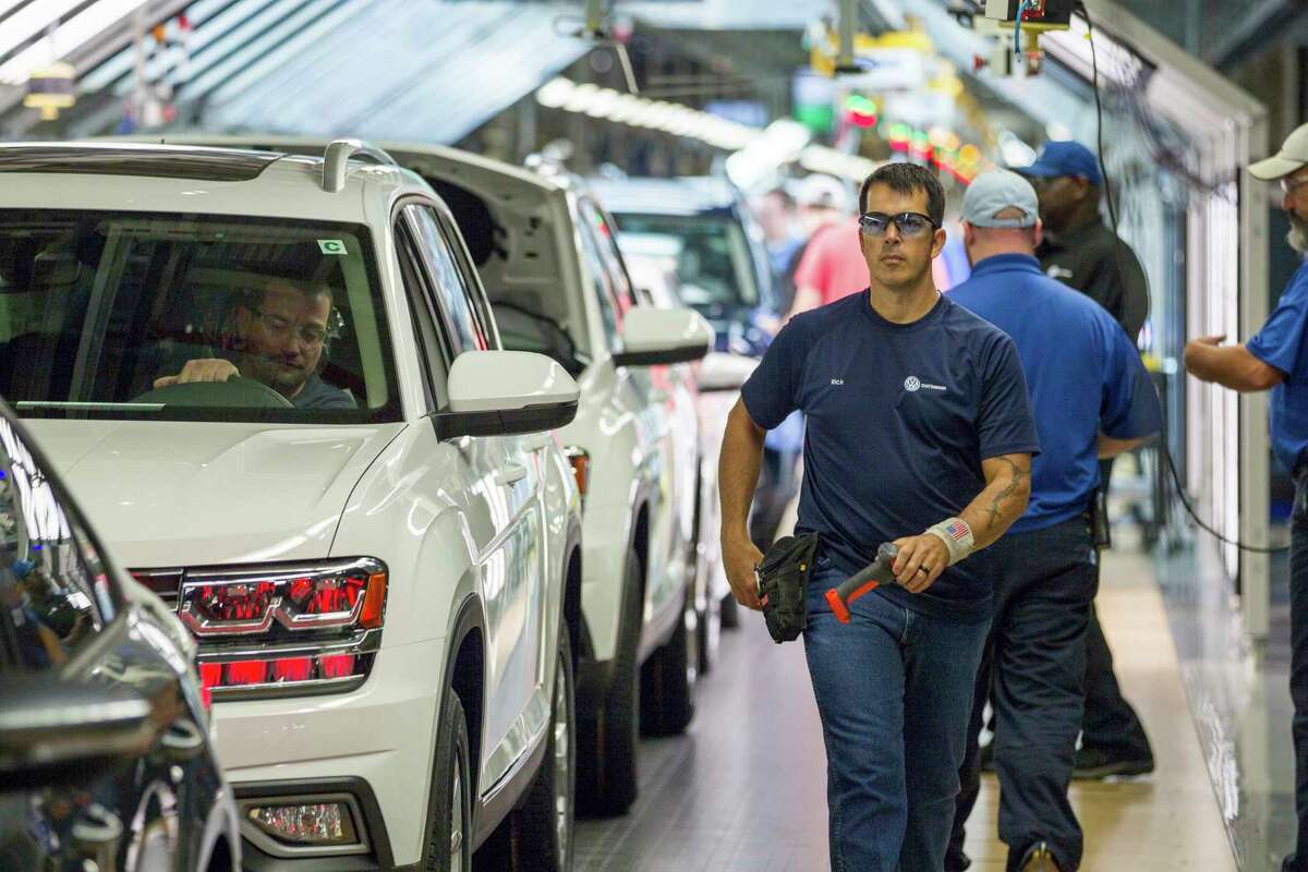 Workers produce vehicles at Volkswagen's lone U.S. plant in Chattanooga, Tenn., on Thursday, Aug. 31, 2017. The plant has begun production of the midsized Atlas SUV alongside the Passat sedan. (AP Photo/Erik Schelzig)