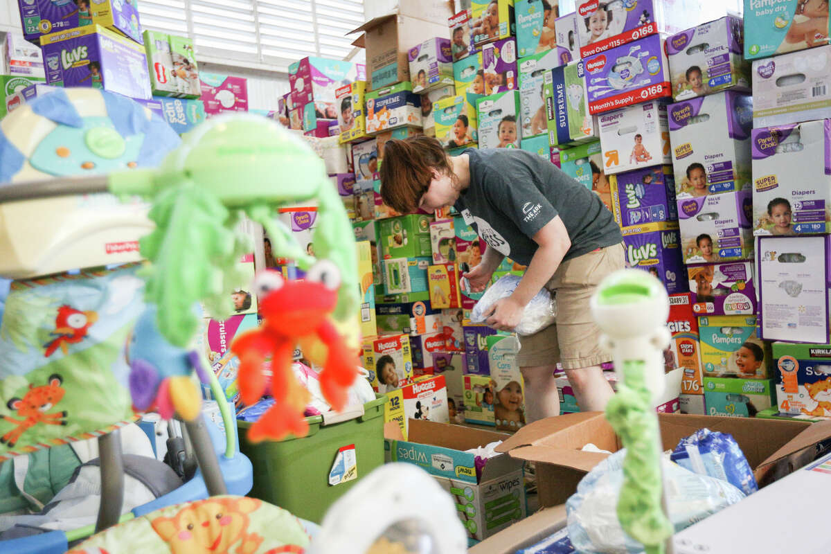 Volunteer Beth Haywood, of The Ark Church, organizes baby-related donations on Friday, Sept. 1, 2017, at Falcon Steel America's warehouse in Conroe. Falcon Steel America donated the space to serve as a central drop off location for supplies to help Montgomery County residents affected by Tropical Storm Harvey.