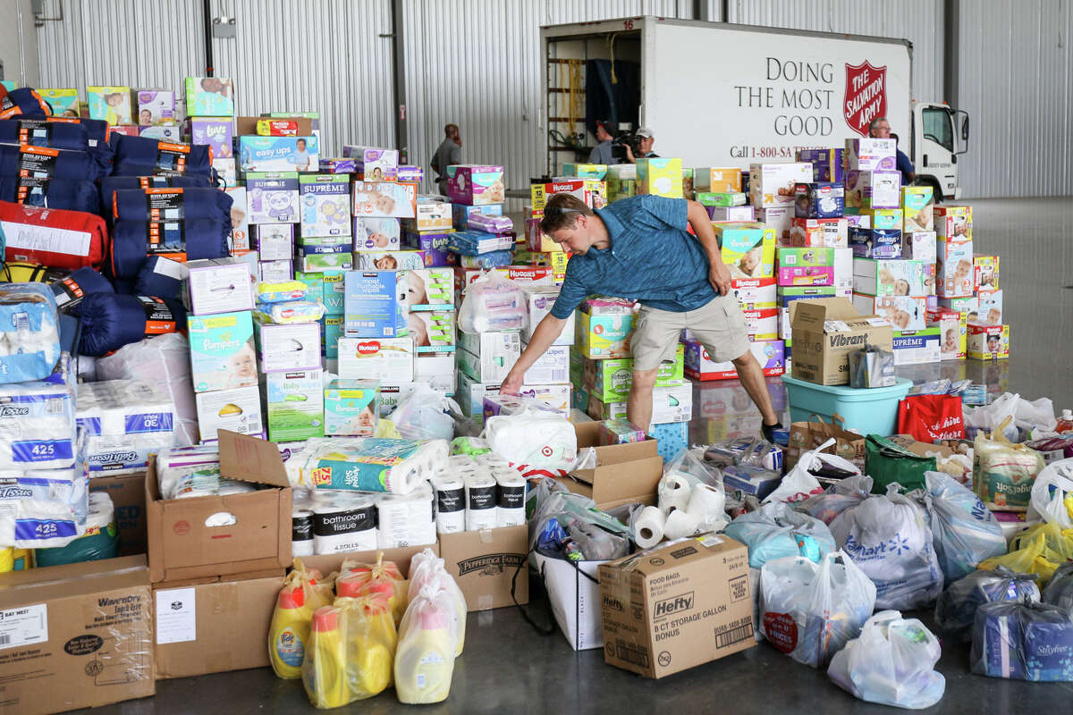 Volunteer Travis Forshee organizes donations as a Salvation Army truck pulls up to begin loading donations during Operation Air Drop on Friday, Sept. 1, 2017, at Conroe-North Houston Regional Airport.