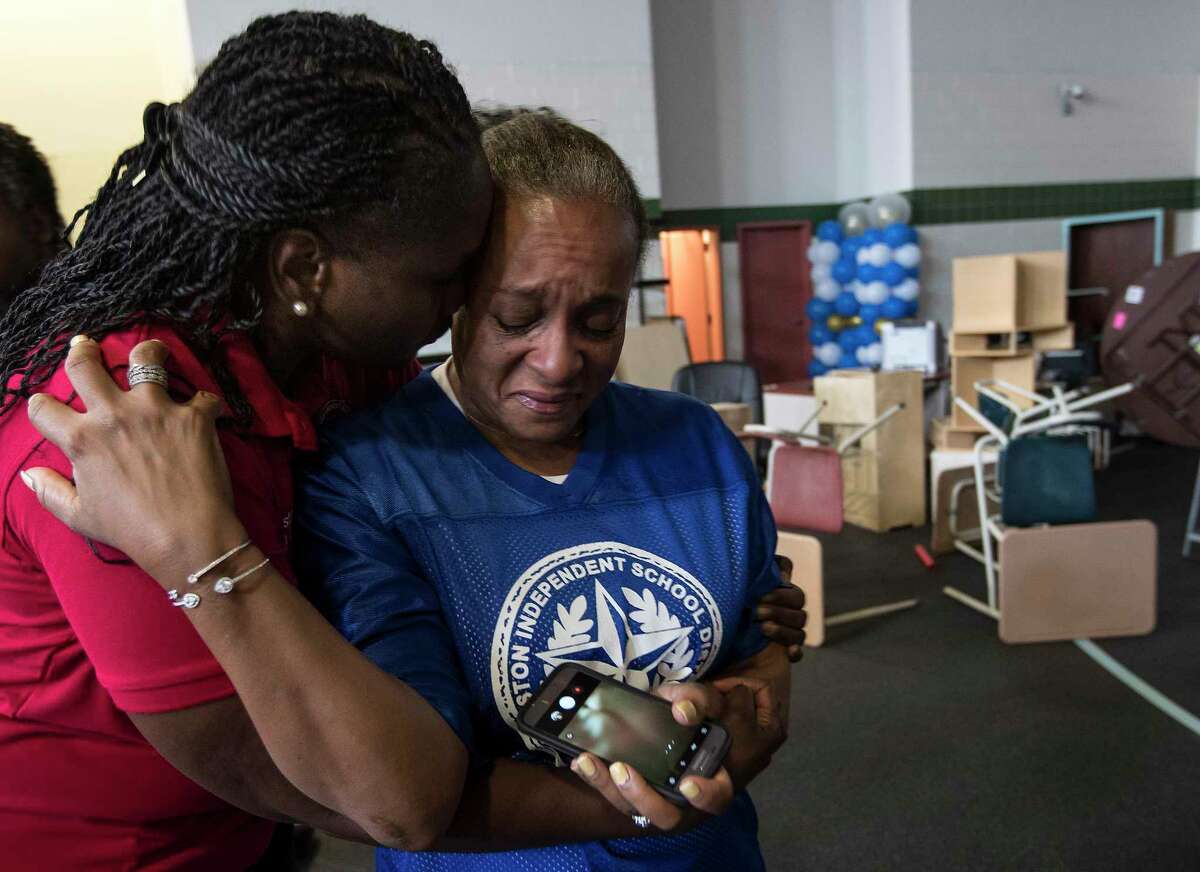 Houston Independent School District President Wanda Adams embraces Rhonda Skillern-Jones, HISD trustee, as they tour flood-damaged A.G. Hilliard Elementary School in the aftermath of Tropical Storm Harvey, on Saturday, Sept. 2, 2017, in Houston.