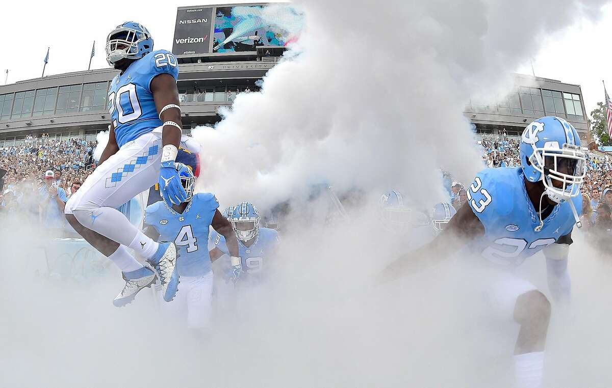 CHAPEL HILL, NC - SEPTEMBER 02: C.J. Cotman #20 and Cayson Collins #23 of the North Carolina Tar Heels lead their team onto the field during their game against the California Golden Bears at Kenan Stadium on September 2, 2017 in Chapel Hill, North Carolina. (Photo by Grant Halverson/Getty Images)