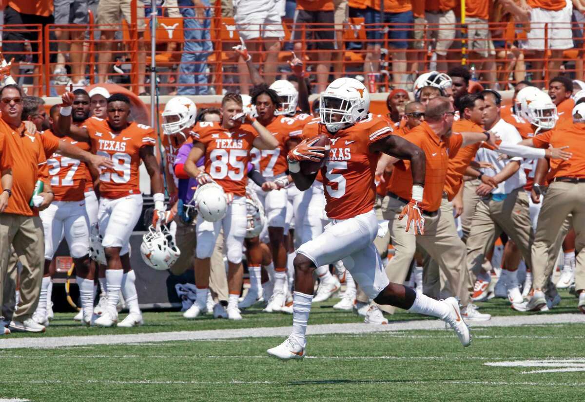 Texas defensive back Holton Hill (5) runs a blocked field goal attempt back for a touchdown during the first half of an NCAA college football game against Maryland, Saturday, Sept. 2, 2017, in Austin, Texas. (AP Photo/Michael Thomas)