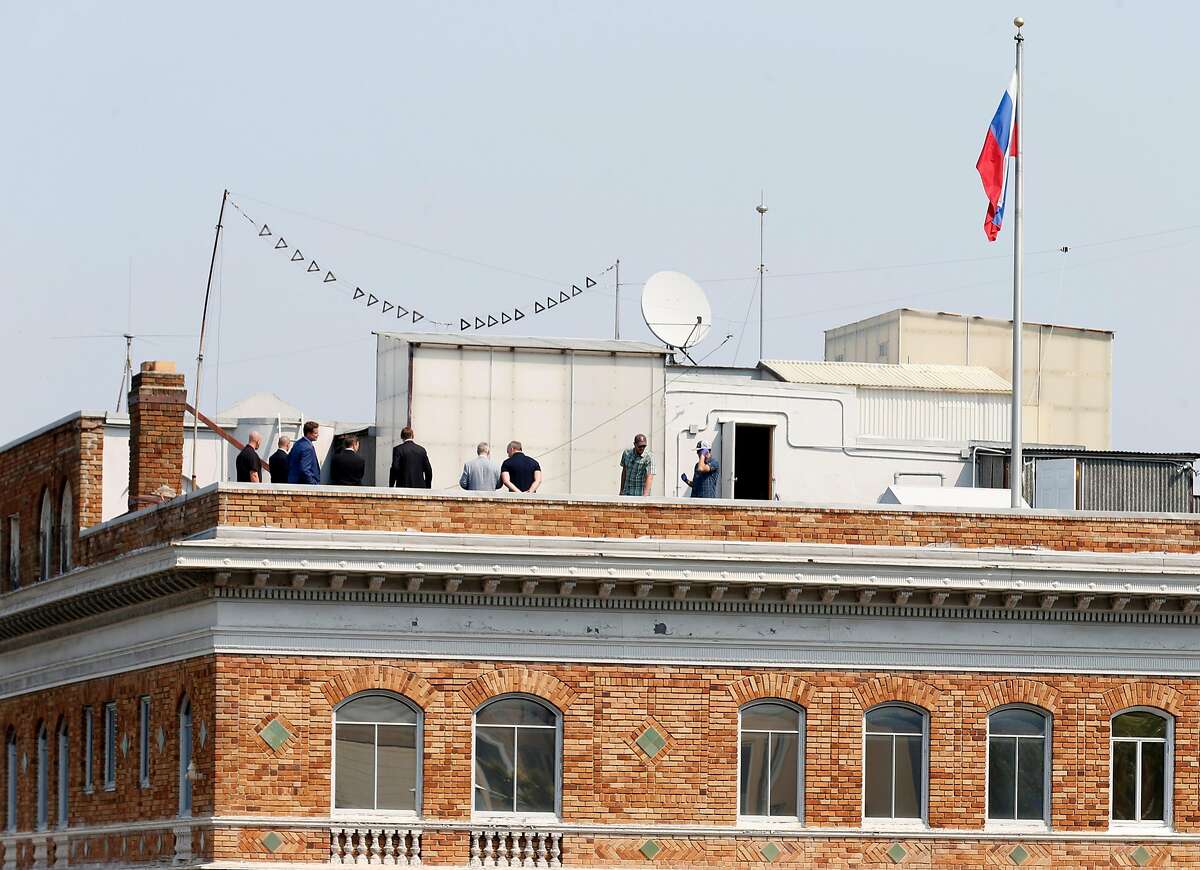A group of men gather on the roof of the Russian Consulate in San Francisco, Calif. on Saturday, Sept. 2, 2017 on the day it was ordered to shut down operations by the Trump Administration.