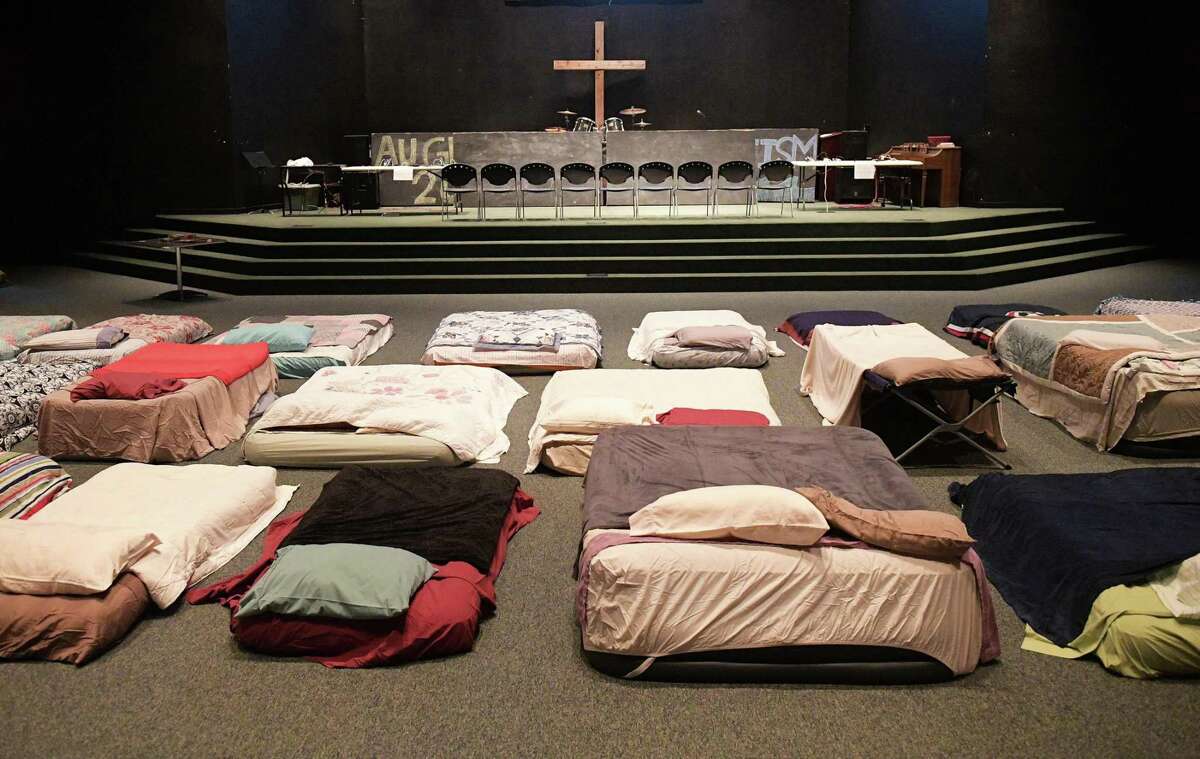 Beds are made ready at a shelter for volunteer rescue workers at Fairfield Baptist Church on Aug. 29, 2017, in Cypress, Texas. Rockport First Assembly of God in Aransas County, Harvest Family Church in Cypress and Hi-Way Tabernacle in Cleveland are suing for disaster relief.