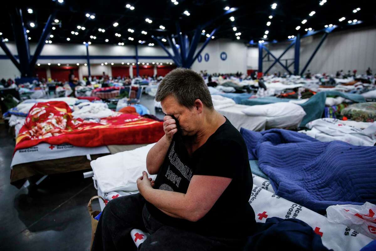 Mary Colson wipes away tears as she sits on a cot at the George R. Brown Convention Center where nearly 10,000 people are taking shelter after Tropical Storm Harvey Wednesday, Aug. 30, 2017 in Houston. "I just don't know where I'm going to go," Colson said. "I'm just so uncertain." ( Michael Ciaglo / Houston Chronicle)