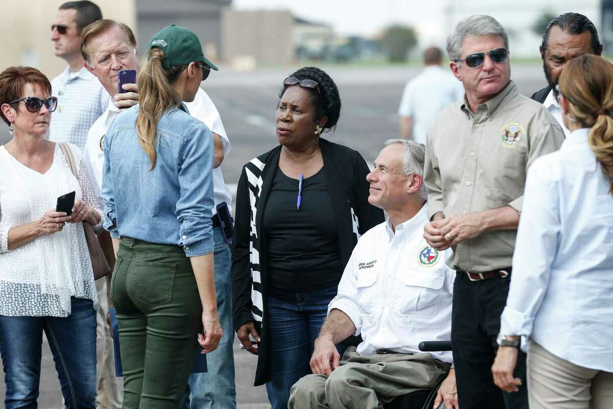 First Lady Melania Trump speaks with congresswoman Sheila Jackson Lee, center, and Texas governor Greg Abbott, right, as she and the president visit Houston in the wake of Tropical Storm Harvey Saturday, Sept. 2, 2017.