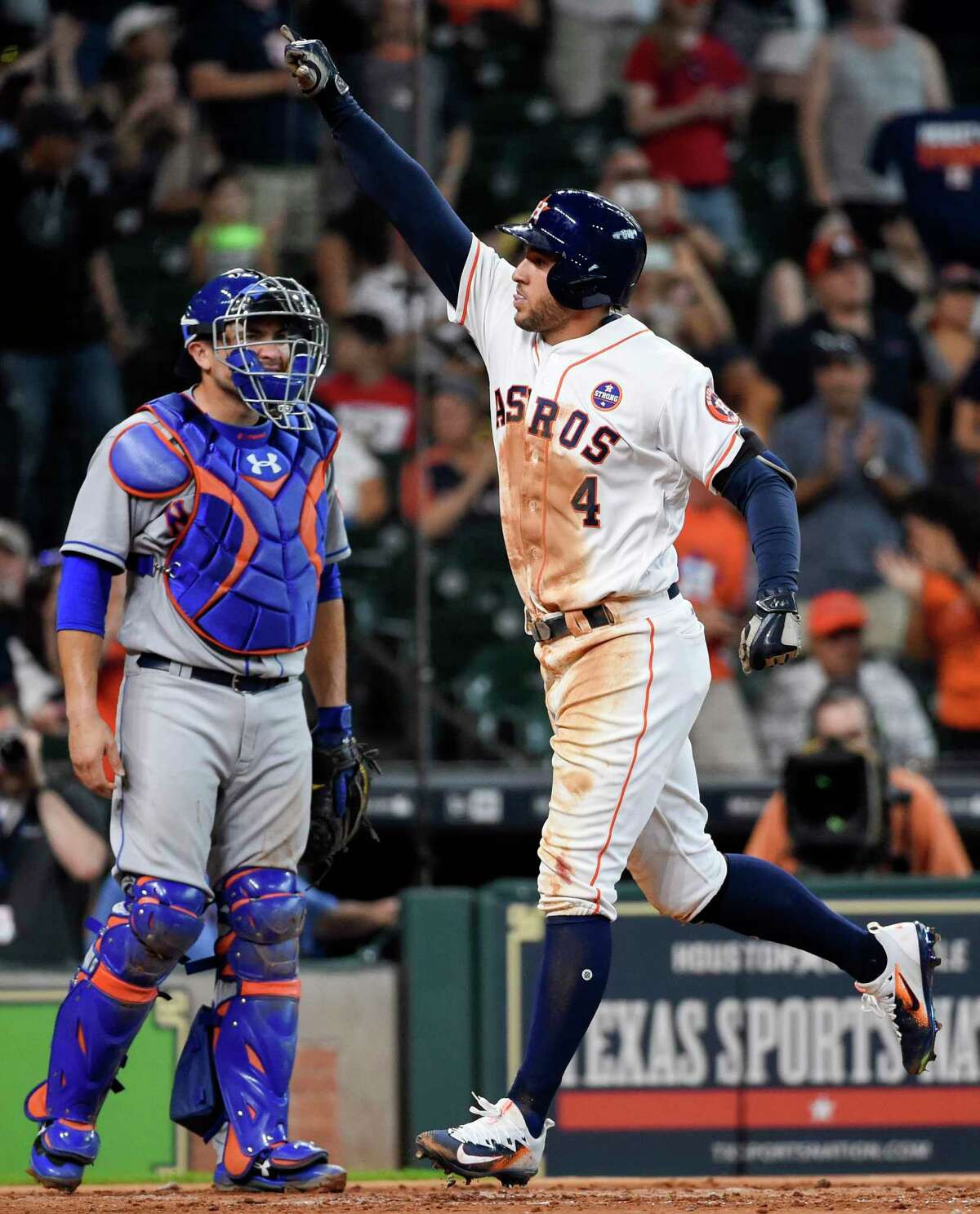 Houston Astros' George Springer (4) celebrates his two-run home run as New York Mets catcher Travis d'Arnaud looks on during the second inning of the first game of a baseball doubleheader, Saturday, Sept. 2, 2017, in Houston. (AP Photo/Eric Christian Smith)