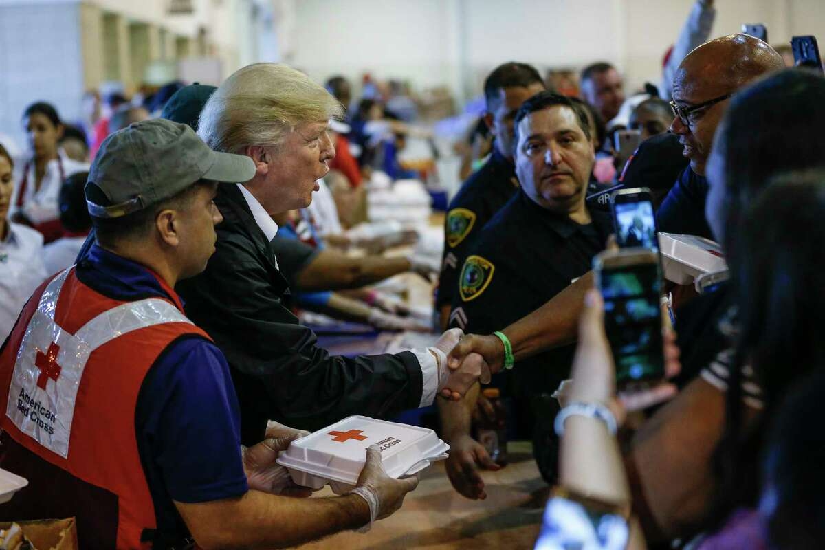 President Donald Trump serves meals to evacuees while visiting the shelter at NRG Center in Houston in the wake of Tropical Storm Harvey Saturday, Sept. 2, 2017.