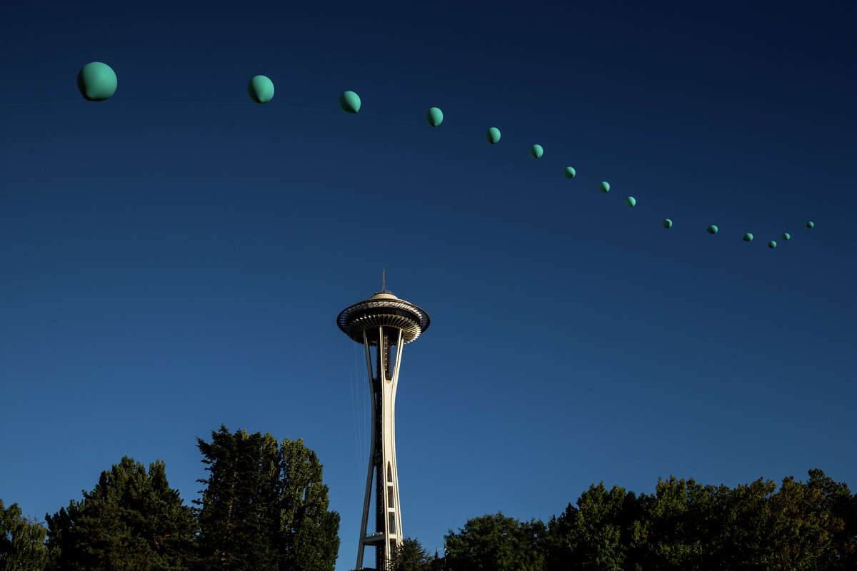 A balloon installation floats across the sky during the second day of Bumbershoot at Seattle Center on Saturday, Sept. 2, 2017.
