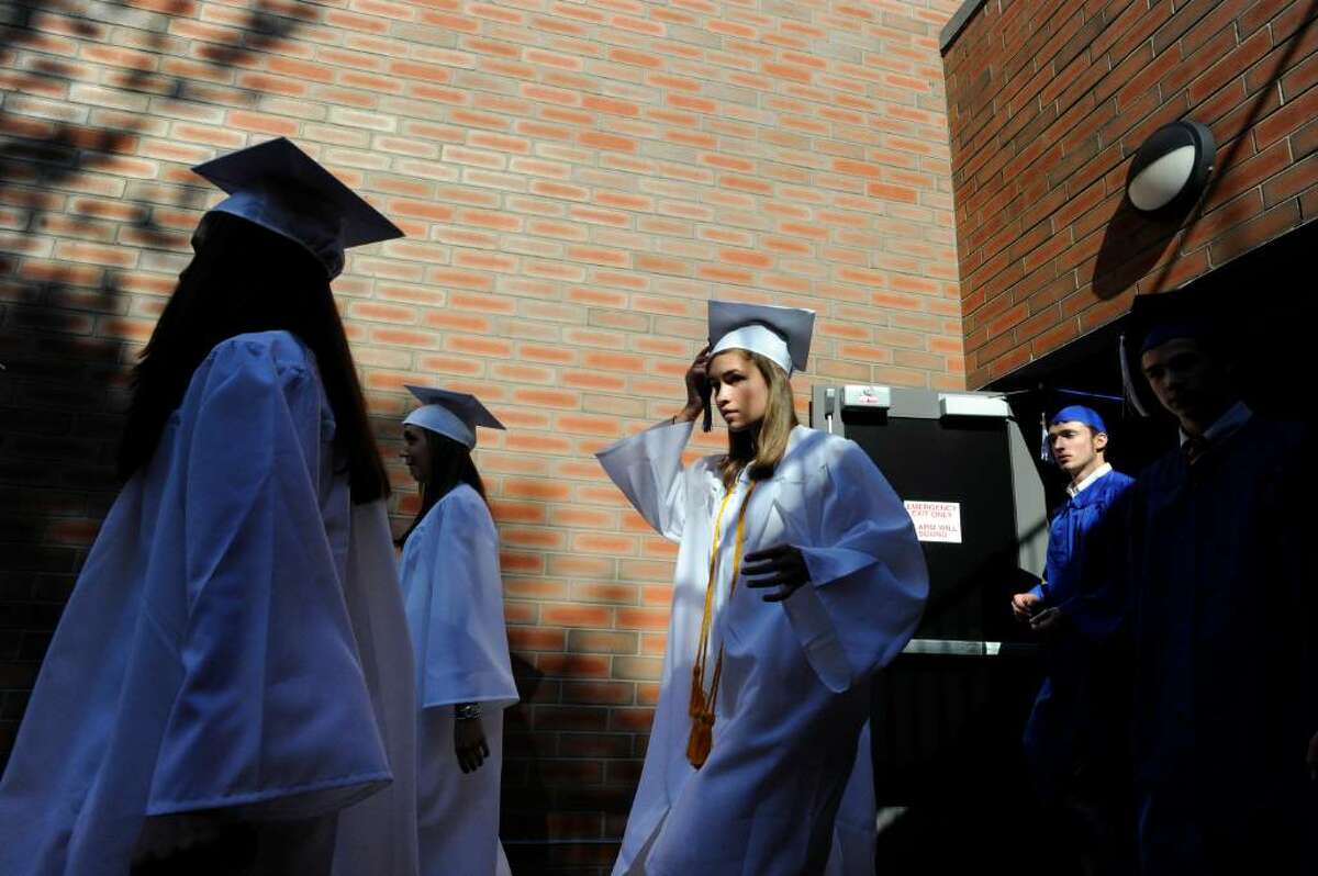 Caroline Vilter adjusts her cap as she heads to the Darien High School Class of 2010 graduation Monday June 21, 2010.