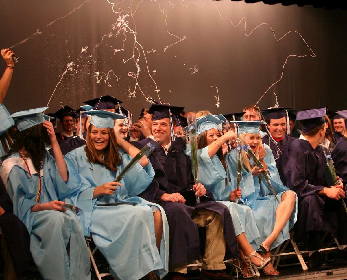 Graduates are showered in silly string by their classmates at the conclusion of Oxford High School's inaugural graduation on Monday, June 21, 2010.