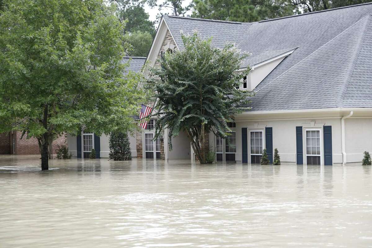 A Kingwood home is covered in 6 to 7 feet of water, flooded by the San Jacinto River in the wake of Harvey. A Kingwood woman fell in her flooded home and ended up dying from flesh-eating bacteria acquired through the injury. Her death was added on Sept. 25 to Harris County’s official list of storm fatalities.