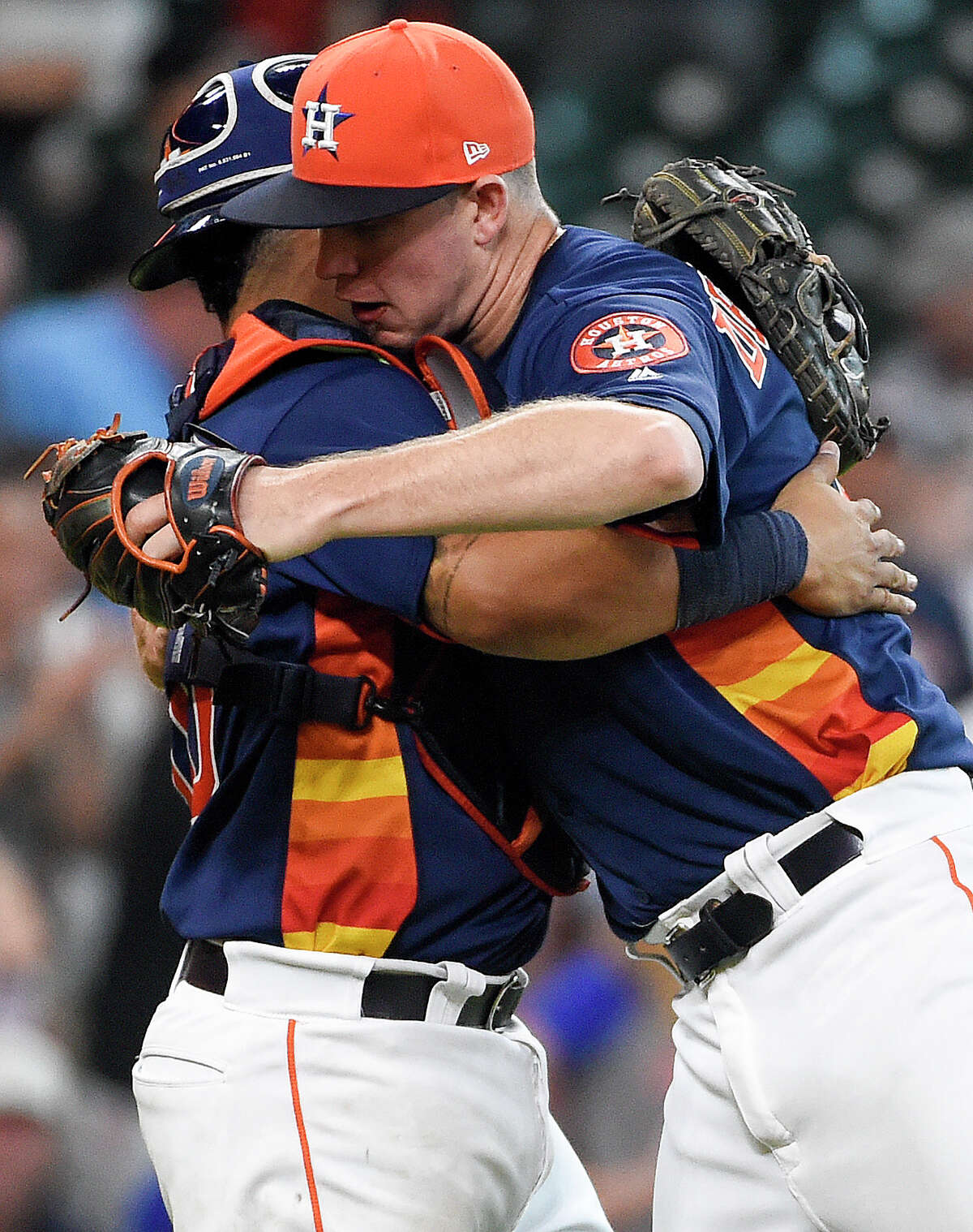 Houston Astros relief pitcher Chris Devenski, right, hugs catcher Juan Centeno after their win over the New York Mets in a baseball game, Sunday, Sept. 3, 2017, in Houston. (AP Photo/Eric Christian Smith)