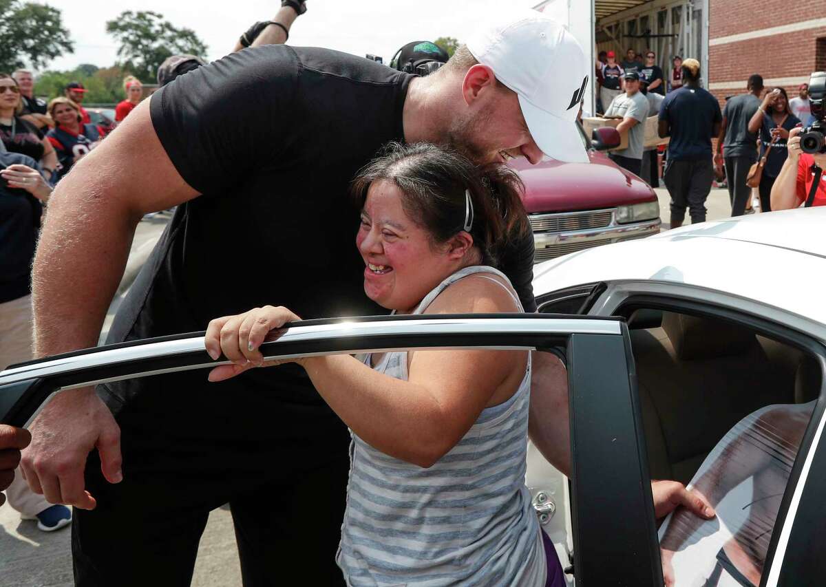 Elvira Vera jumps out of her car to embrace Houston Texans defensive end J.J. Watt as he distributing relief supplies to people impacted by Hurricane Harvey on Sunday, Sept. 3, 2017, in Houston. J.J. Watt's Hurricane Harvey Relief Fund, which raised more than $17 million to date to help those affected by the storm.