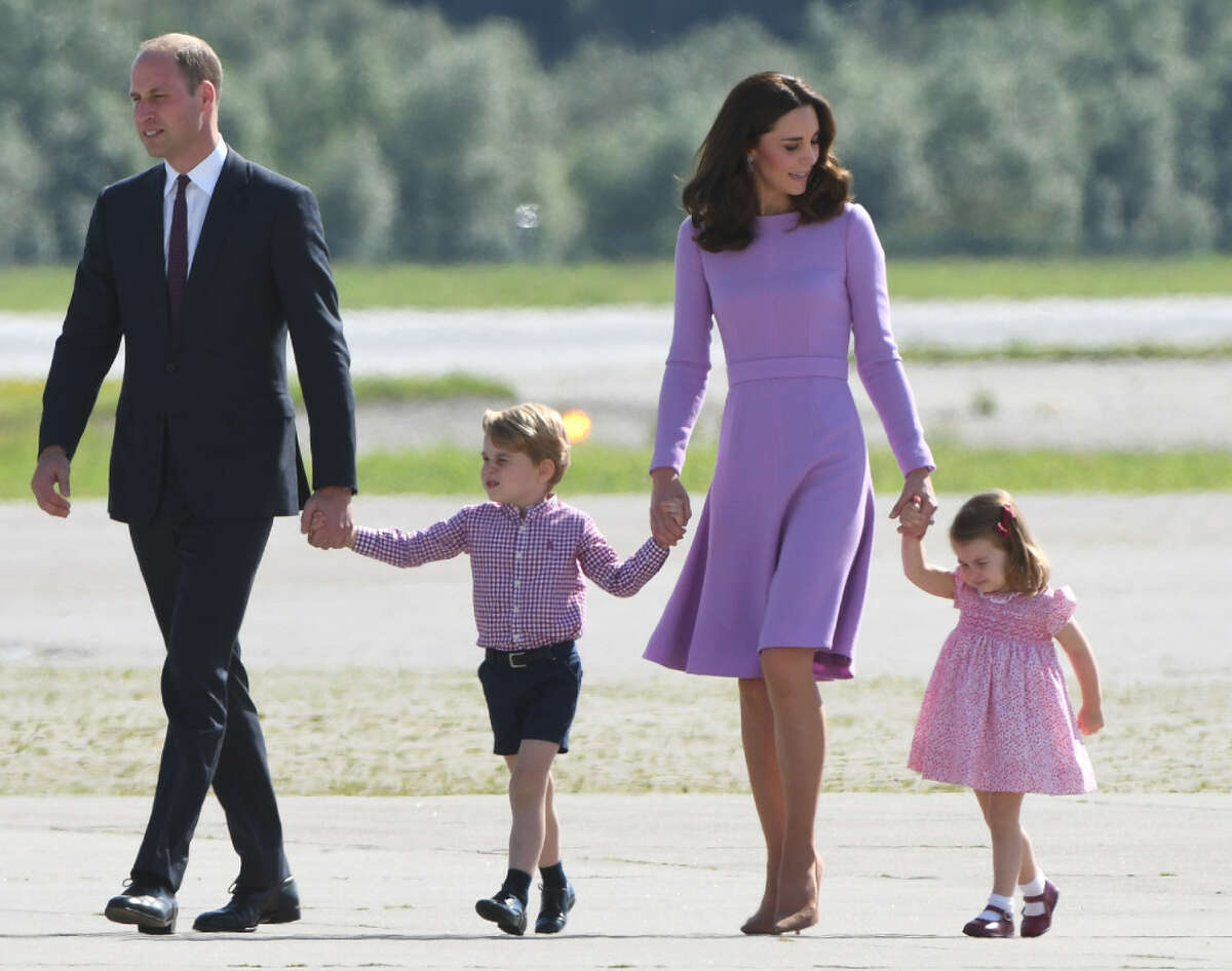 (FILES) This file photo taken on July 21, 2017 shows Britain's Prince William, Duke of Cambridge and his wife Kate, the Duchess of Cambridge, and their children Prince George and Princess Charlotte on the tarmac of the Airbus compound in Hamburg, northern Germany.Prince William and his wife Kate are expecting their third child, Kensington Palace announced on September 4, 2017, adding that she would not be attending a planned engagement due to a severe form of morning sickness. / AFP PHOTO / Patrik STOLLARZPATRIK STOLLARZ/AFP/Getty Images ORG XMIT: -