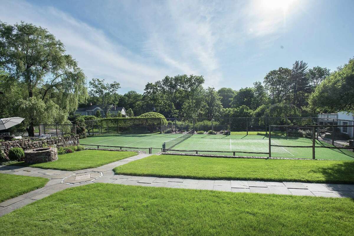 On the Market / New Canaan house with pool, tennis and orchard is set