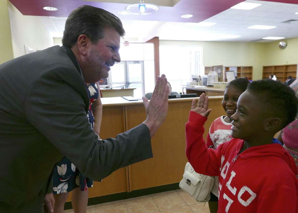 Southside ISD Superintendent Mark Eads offers a high-five to new student Ronnie Spencer as his sister, Raniyah, looks on on Tuesday, Aug. 8, 2017, the first day of registration. Ronnie will be in the third grade while Raniya will be in the fourth grade.