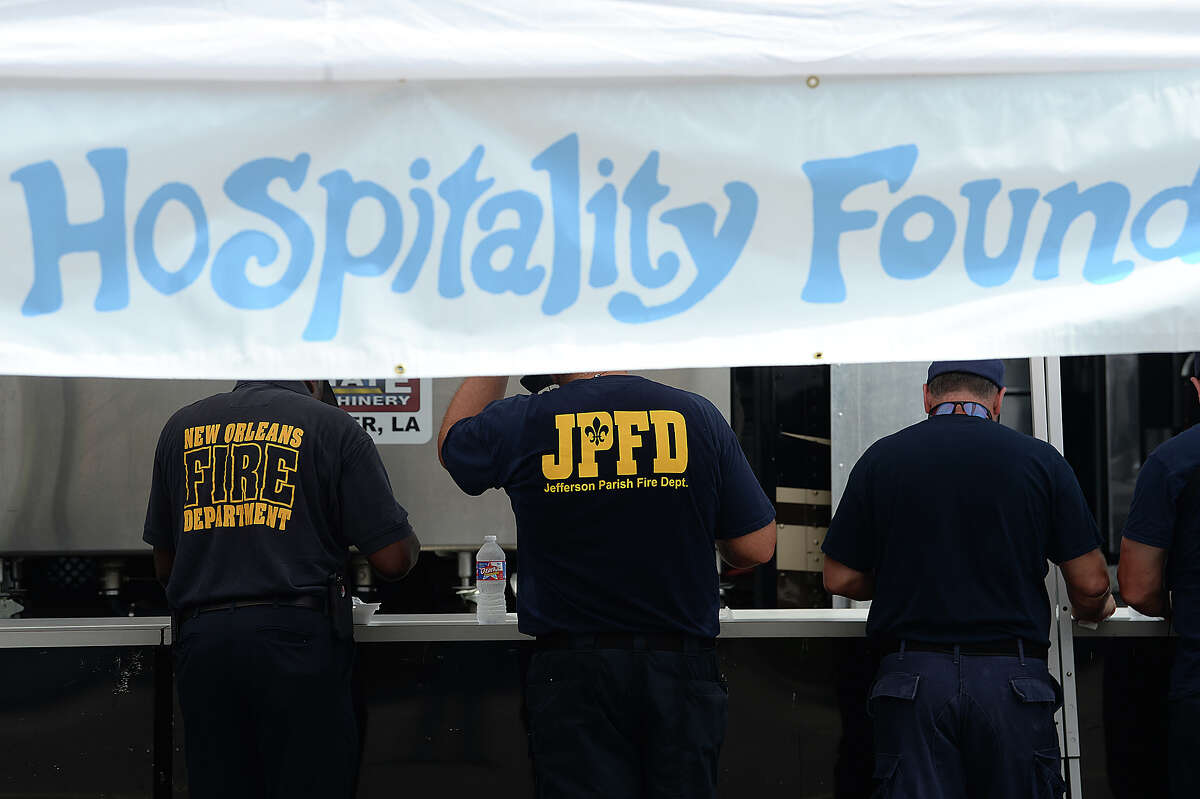 Firefighters from New Orleans and Jefferson Parrish in Louisiana stop for food the Louisiana Hospitality Foundation's set-up in west Port Arthur Monday. They are among the first responders from throughout the country that have convened on towns throughout Southeast Texas as they help in rescue and recovery efforts for flood victims. Photo taken Monday, September 4, 2017 Kim Brent/The Enterprise
