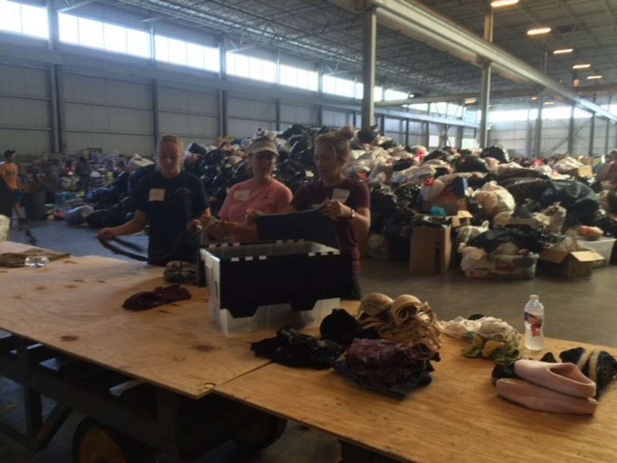 Volunteers sort through donated clothing at a distribution center in Conroe for Harvey victims on Monday, Sept.4.