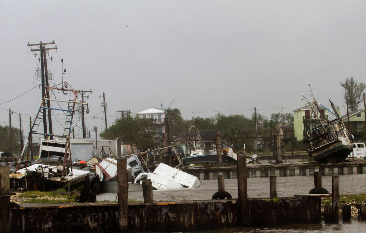 In this Aug. 26, 2017 photo, shrimp and oyster boats are strewn about in the Seadrift, Texas docks after Hurricane Harvey hit the area. (Nicolas Galindo/The Victoria Advocate via AP)