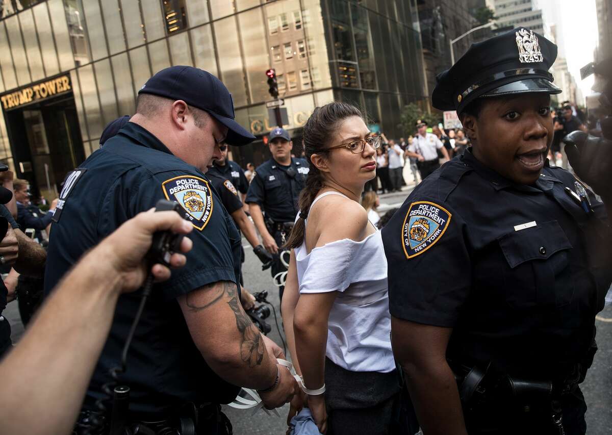Immigration activists protesting the Trump administration's decision on the Deferred Action for Childhood Arrivals are arrested by New York City Police (NYPD) officers after they sat in the street and blocked traffic on 5th Avenue near Trump Tower, September 5, 2017. On Tuesday, the Trump administration announced they will end the Deferred Action for Childhood Arrivals program, with a six month delay. The decision represents a blow to young undocumented immigrants (also known as 'dreamers') who were shielded from deportation under DACA.