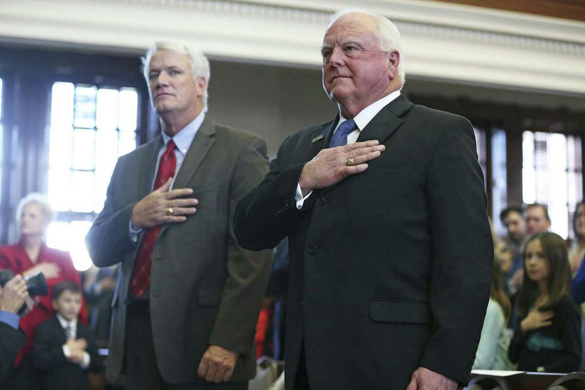 Rep. Lyle Larson, R-San Antonio, and Agriculture Commissioner Sid Miller stand at attention during the anthem earlier this year. Miller’s spokesman said Tuesday the decision to reduce fees is unrelated to a state audit.