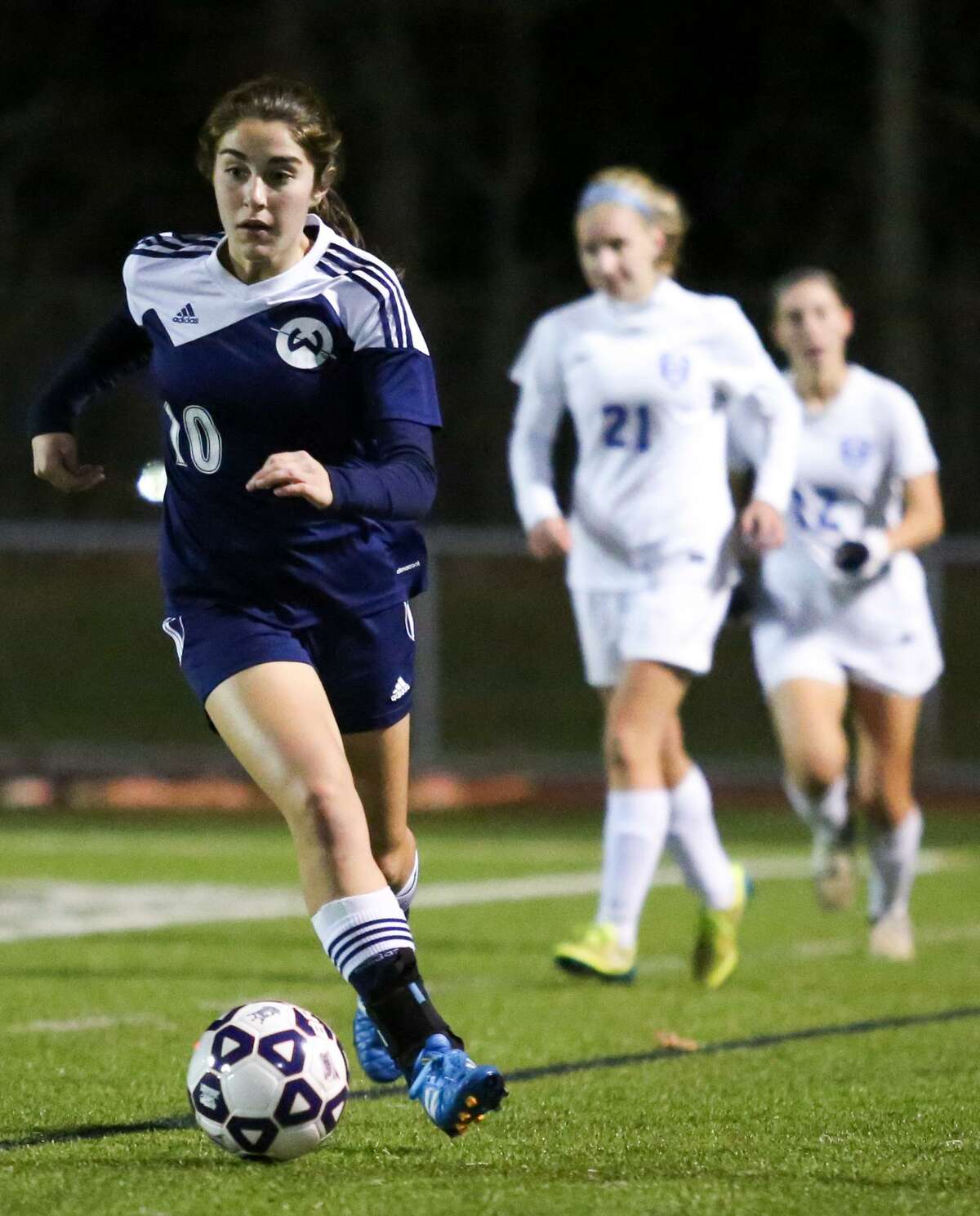 Wilton's Zoe Lash keeps the ball from Glastonbury defense during the Class LL girls soccer semifinals in West Haven, Conn. on Wednesday, November 16, 2016.