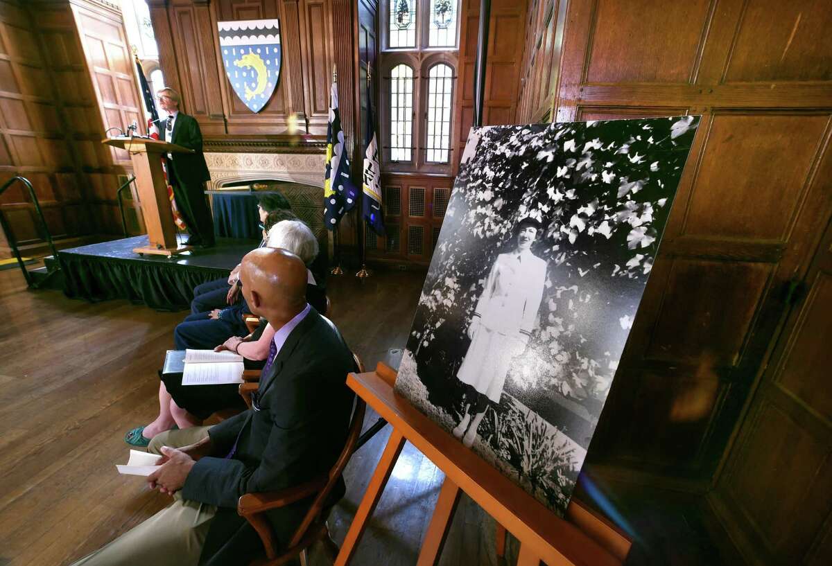 Roger Murray III (left), nephew of Grace Hopper, speaks at the dedication of Grace Hopper College at Yale University in New Haven on 9/5/2017. At right is a photograph of Grace Hopper. Arnold Gold / Hearst Connecticut Media