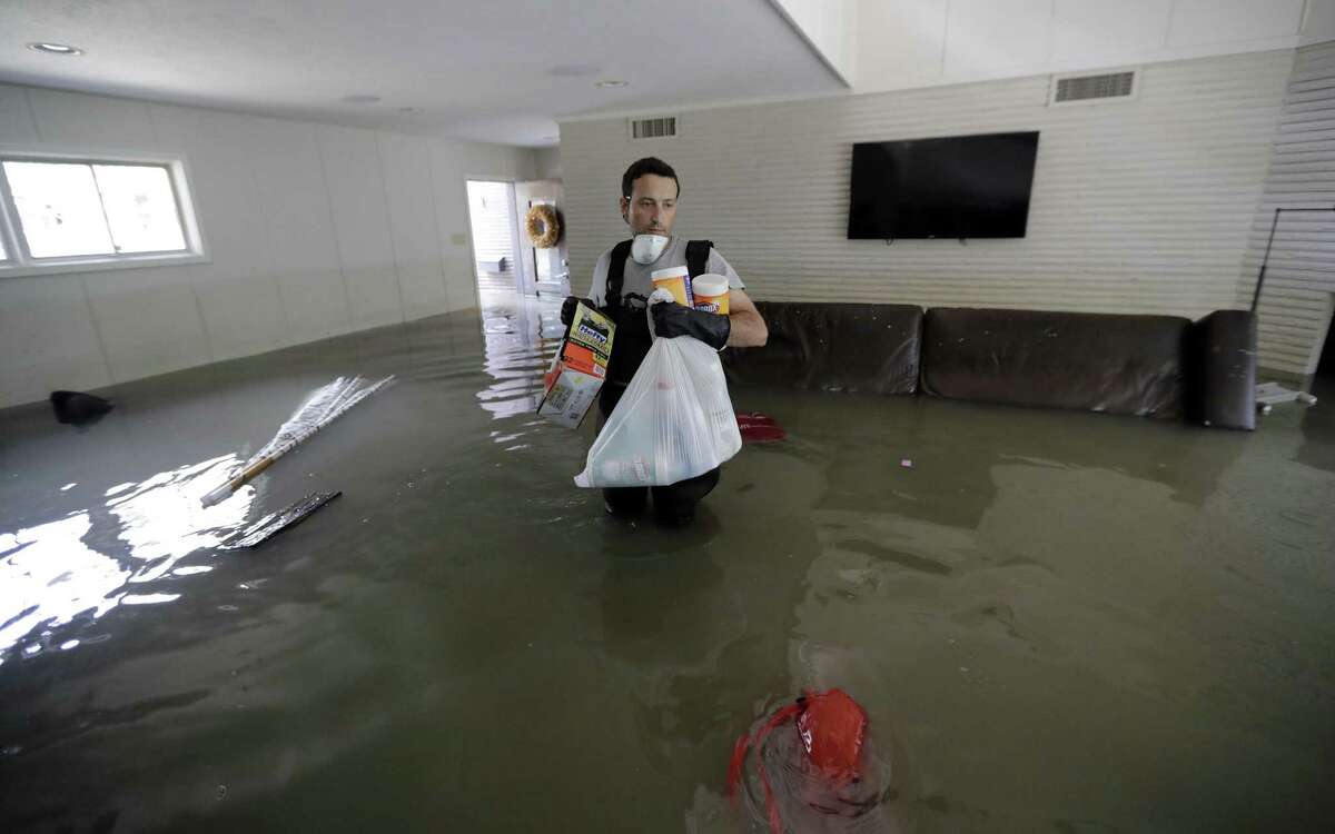 Gaston Kirby walks through floodwater inside his home near the Addicks and Barker reservoirs in the aftermath of Harvey.