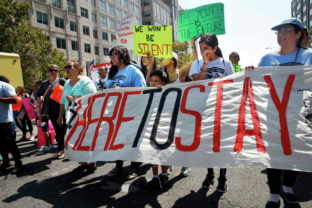 Cielo Mendez, 17, of Plainfield, N.J., who is a DACA recipient, second from left with banner, marches next to Gabriel Henao, 7, and Kimberly Armas, 15, of Elizabeth, N.J., in support of the Deferred Action for Childhood Arrivals program, known as DACA, outside of Immigration and Customs Enforcement (ICE), in Washington, Tuesday, Sept. 5, 2017. President Donald Trump plans to phase out the DACA program that has protected hundreds of thousands of young immigrants brought into the country illegally as children and call for Congress to find a legislative solution. (AP Photo/Jacquelyn Martin)