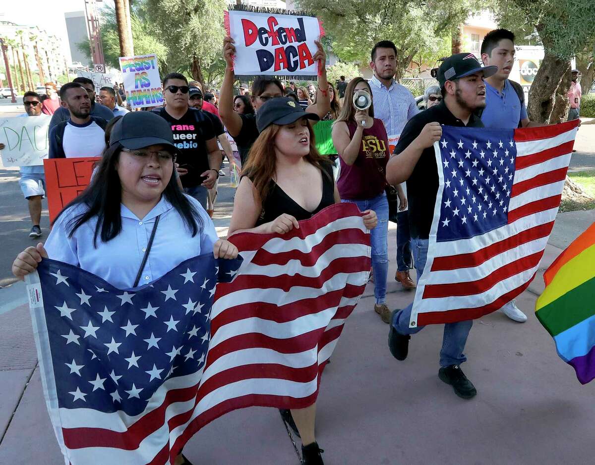 Deferred Action for Childhood Arrivals (DACA) supporters march to the Immigration and Customs Enforcement office to protest shortly after U.S. Attorney General Jeff Sessions' announcement that the Deferred Action for Childhood Arrivals (DACA), will be suspended with a six-month delay, Tuesday, Sept. 5, 2017, in Phoenix. (AP Photo/Matt York)