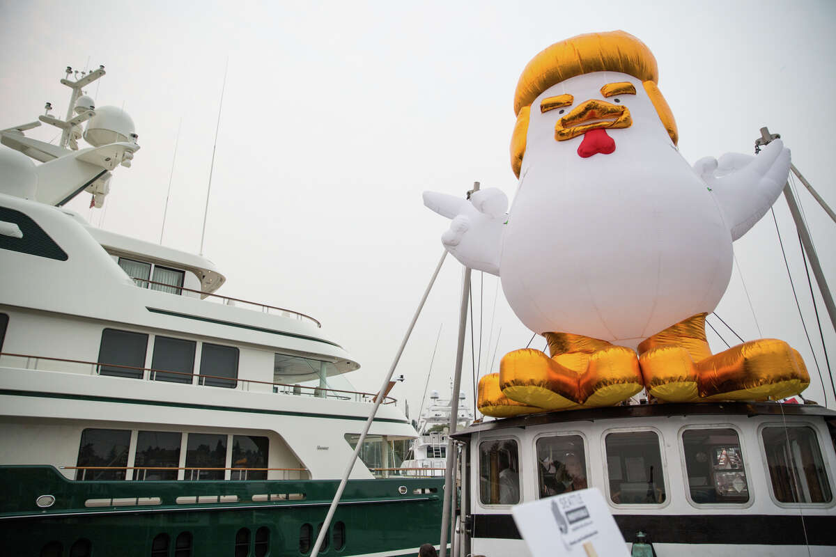 An inflatable Trump chicken aboard a boat floats next to Breitbart benefactor Robert Mercer's yacht on Lake Union in Seattle on Tuesday, Sept. 5, 2017.