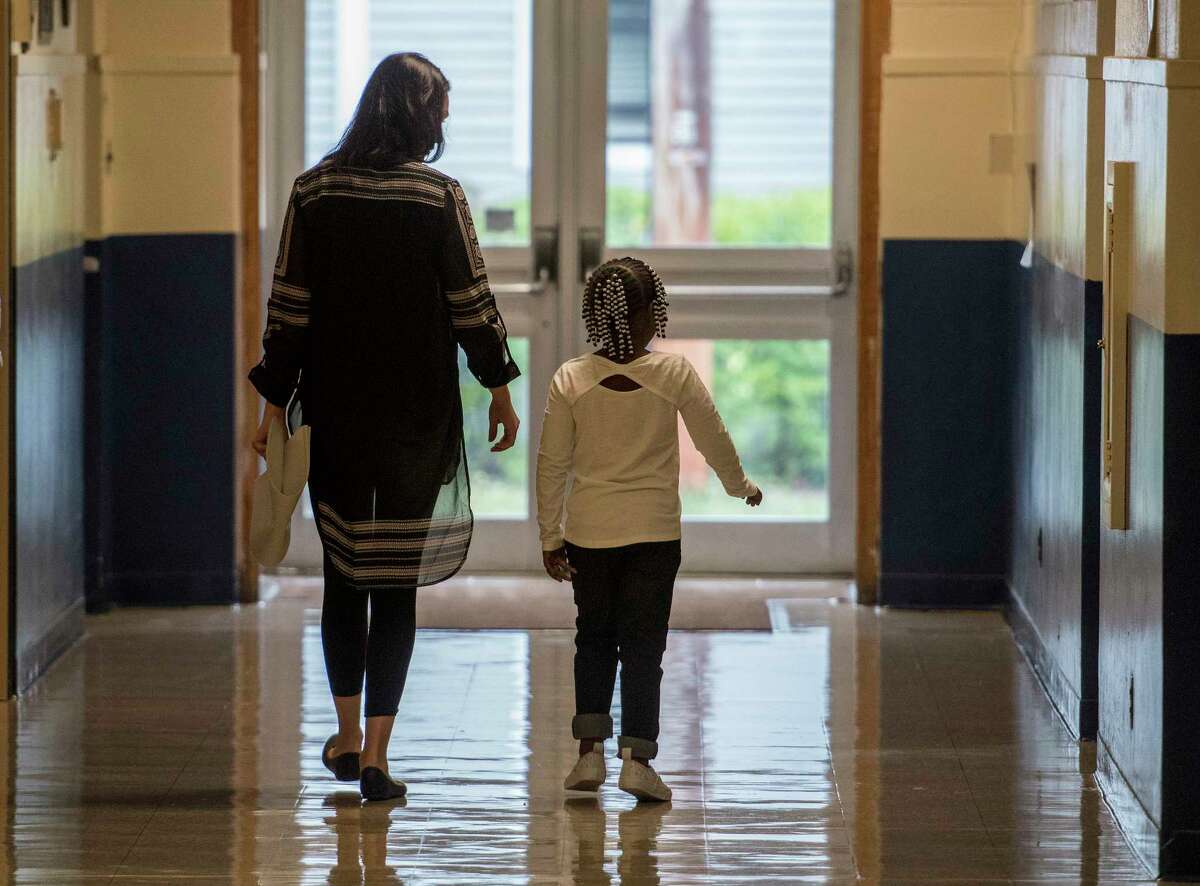 A student walks with a teacher through the hallway on the first day of school at the Lake Avenue Elementary School on Wednesday, Sept. 6, 2017, in Saratoga Springs, N.Y. (Skip Dickstein/Times Union)