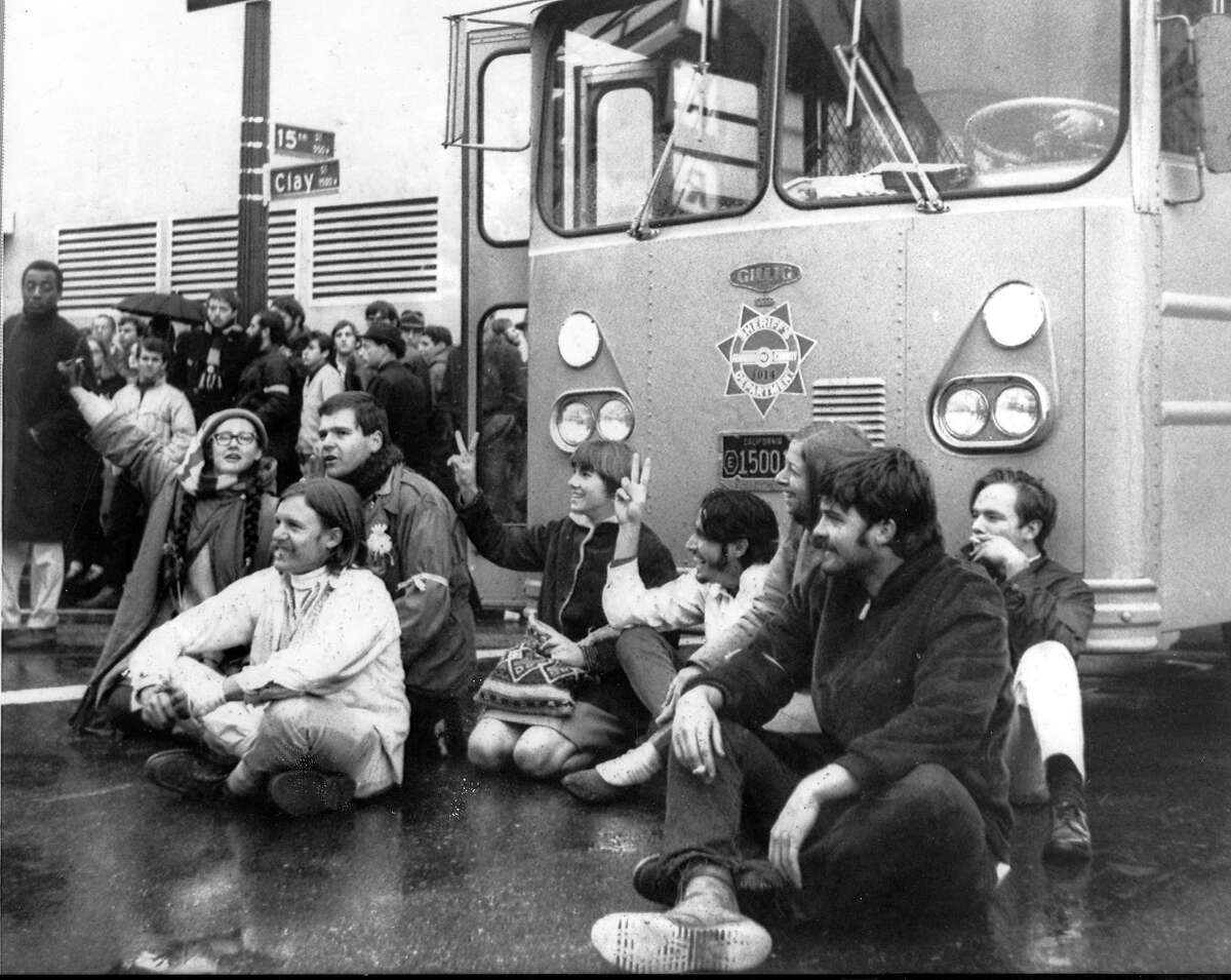 Anti-war demonstrators sit in the street blocking access to the Oakland Induction Center at Clay and 15th streets in Oakland , December 18, 1967 Vietnam War protesters United Press International