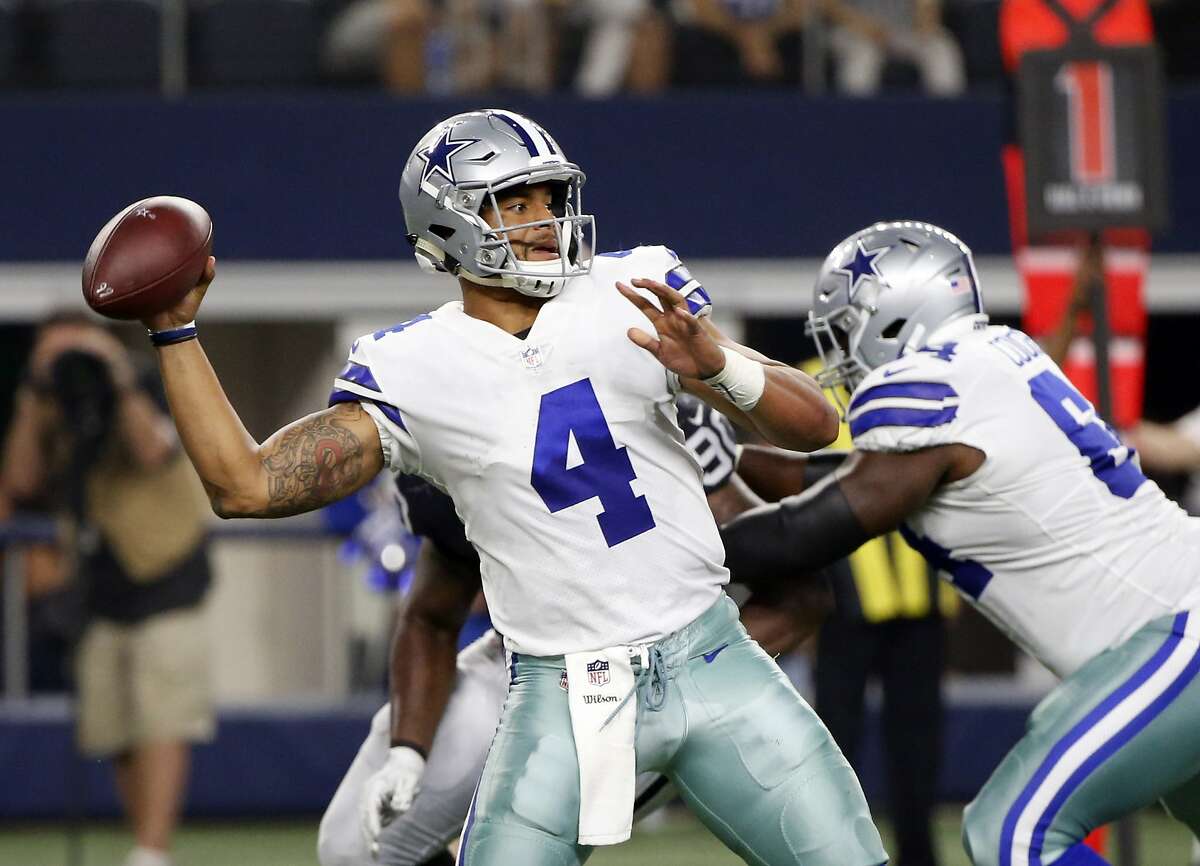 FILE - In this Saturday, Aug. 26, 2017, file photo, Dallas Cowboys' Dak Prescott (4) throws a pass in the first half of a preseason NFL football game against the Oakland Raiders in Arlington, Texas.