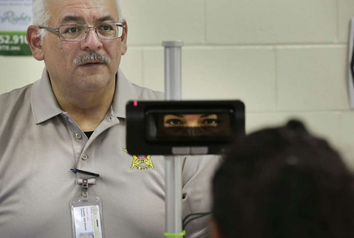 Lt. Joe Elizardi scans an inmate's eyes at Carrizales-Rucker Detention Center in Olmito, TX, on Friday Aug. 18, 2017.